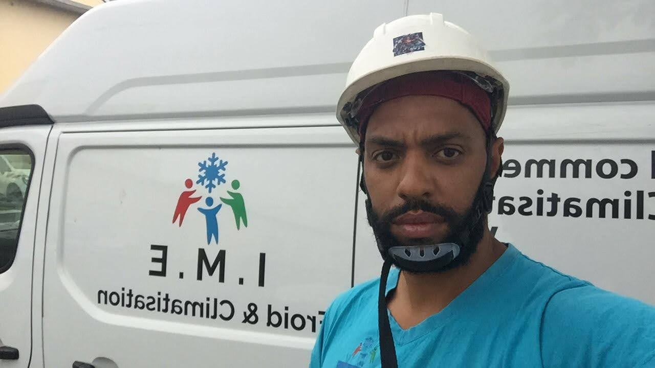 Artisan IMEFC devant son véhicule d'intervention à La Réunion